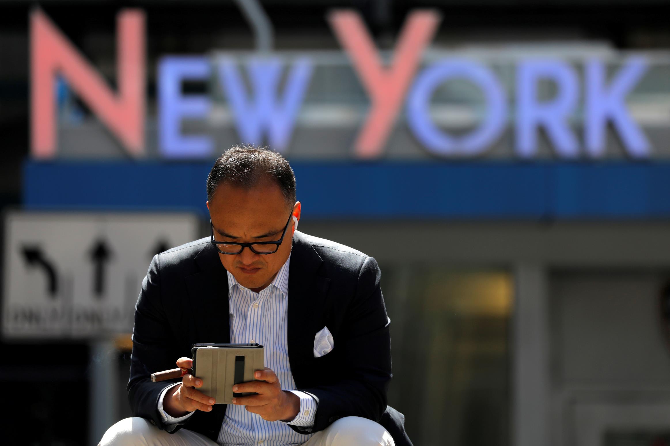 A person sits in Times Square after the Centers for Disease Co<em></em>ntrol and Prevention (CDC) announced new guidelines regarding outdoor mask wearing and vaccination during the outbreak of the coro<em></em>navirus disease (COVID-19) in Manhattan, New York City, New York, U.S., April 27, 2021. REUTERS/Andrew Kelly