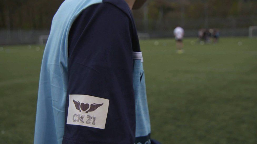 Tribute badge to Christopher on the sleeves of a football shirt